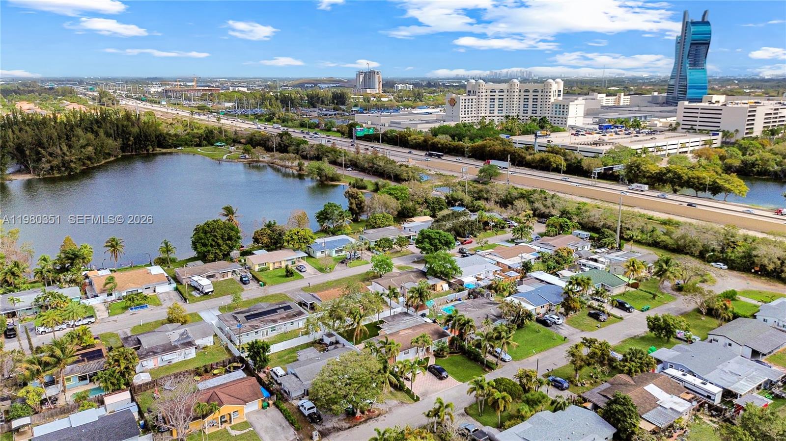 An aerial view shows a residential neighborhood situated next to a lake and highway — 5220 SW 57th St, Davie FL 33314, DAVIE, FL