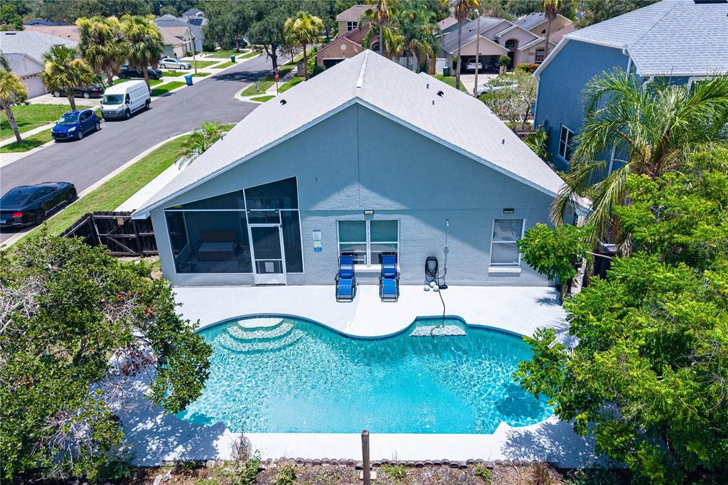 An aerial view of a house with a screened-in patio and a kidney-shaped swimming pool — 2180 TORTOISE SHELL DRIVE, MAITLAND, FL
