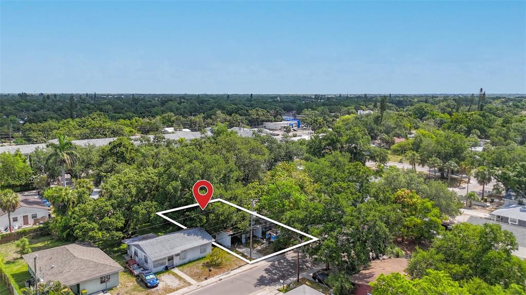 An aerial view shows a small house with a white outline marking the property boundaries — 1679 24TH STREET, SARASOTA, FL