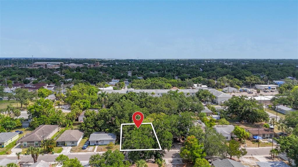 An aerial view shows a residential lot outlined in white amidst a neighborhood with trees — 1679 24TH STREET, SARASOTA, FL