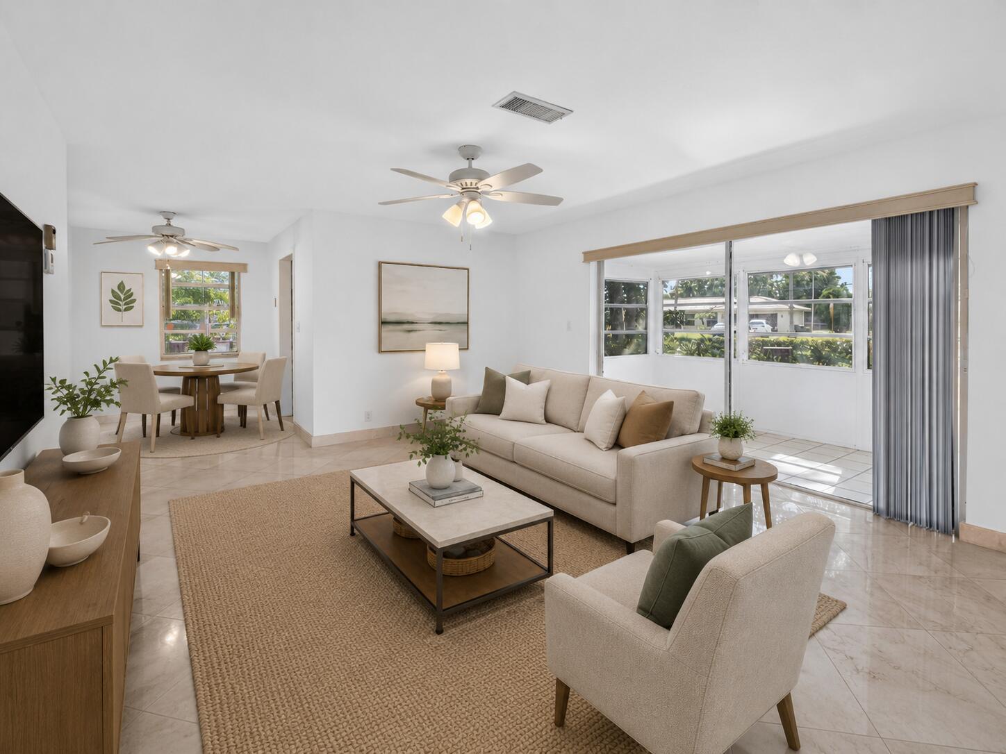 A living room with a beige sofa, armchair, coffee table, and an adjacent dining area — 300 NW 42nd Street, Boca Raton FL 33431, BOCA RATON, FL