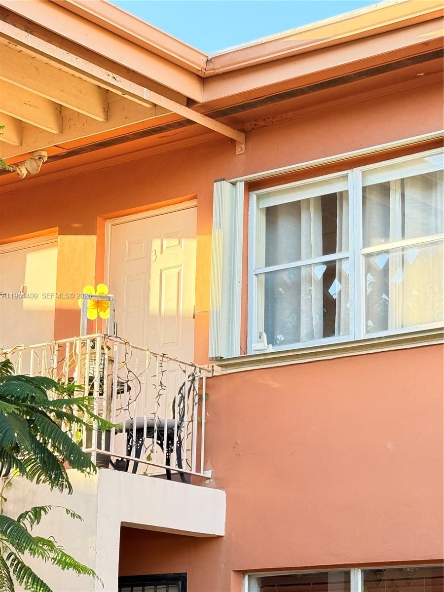 A view of a building exterior featuring a balcony, a door, and a window — 3411 SW 11th St # 3B, Miami FL 33135, MIAMI, FL