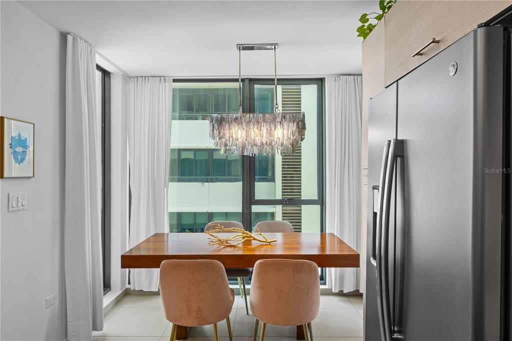 A dining area features a wooden table, four pink chairs, and a decorative chandelier — 1511 PONCE DE LEON AVENUE UNIT 851, SAN JUAN, PR