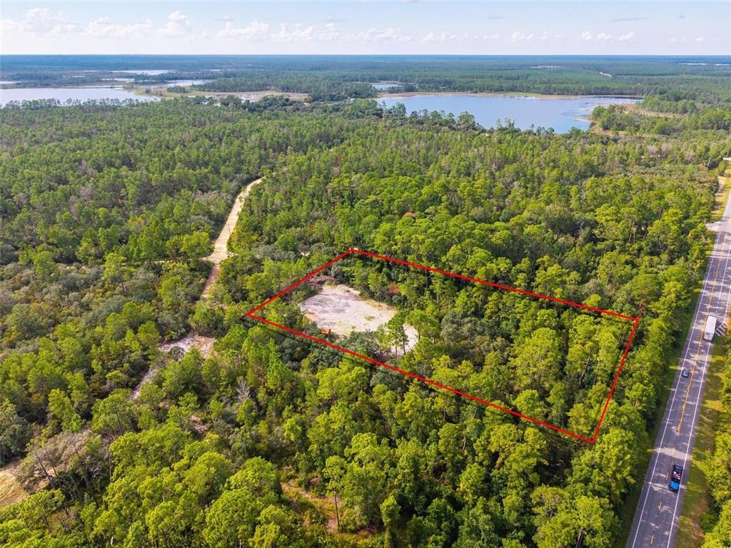 An aerial view shows a rectangular plot of land outlined in red near a road — 52215 STATE ROAD 19, ALTOONA, FL