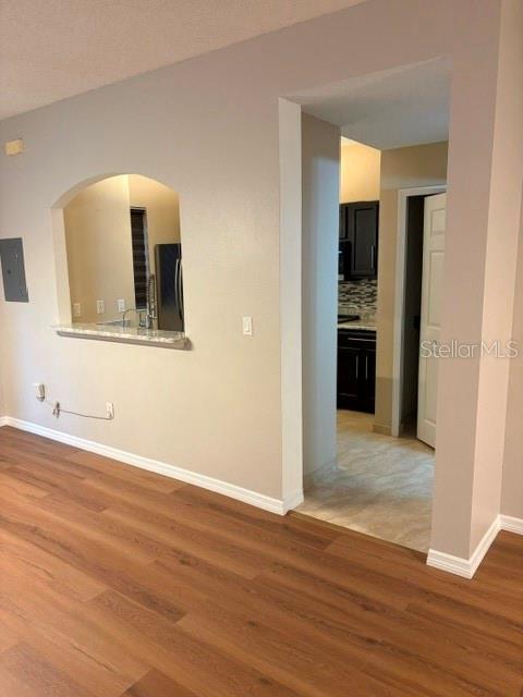 A view from a living area looking through an arched pass-through into a kitchen — 18157 PARADISE POINT DRIVE, TAMPA, FL