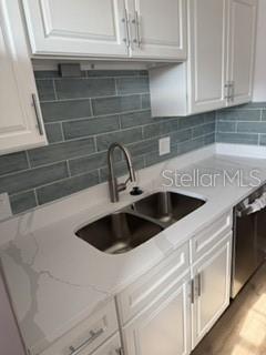 A kitchen sink with a gooseneck faucet is set into a white quartz countertop — 1134 RUE DES ROIS UNIT 1134, ST PETERSBURG, FL