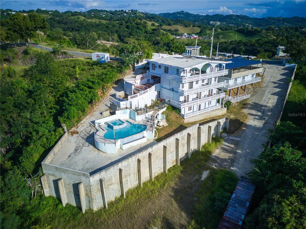 An aerial view of a multi-story white house with a swimming pool and retaining wall — Carr. 115 KM 11.4 INT SECTOR JULIO SOTO, RINCON, PR
