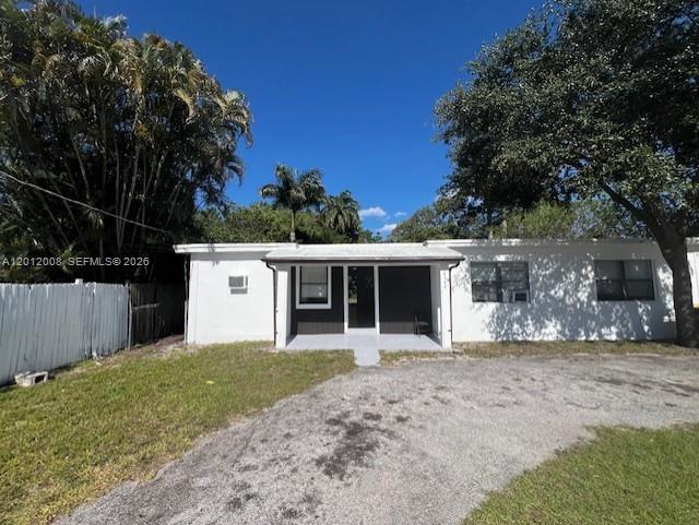 A single-story white house with a covered front porch and a gravel driveway — 4548 SW 33rd Ave # M, Dania Beach FL 33312, DANIA BEACH, FL