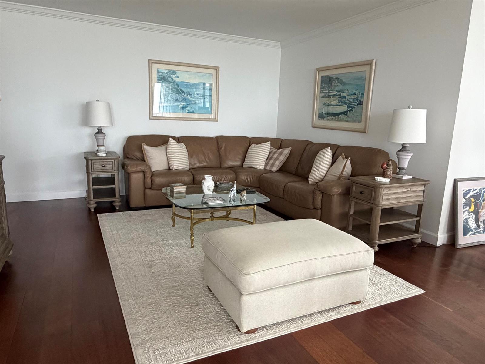 A living room features a brown leather sectional sofa, a glass coffee table, and an ottoman — 1800 S Ocean Boulevard Unit 612, Pompano Beach FL 33062, POMPANO BEACH, FL