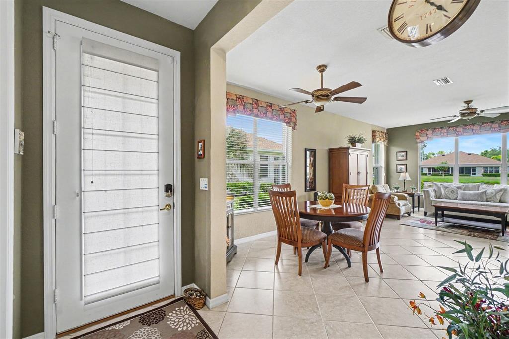 An entryway leads into an open-concept dining area and living room with tile flooring — 2593 COTTONWOOD LANE, NORTH PORT, FL