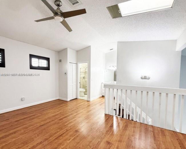 An interior room features wood flooring, a ceiling fan, and a staircase with white railings — 4182 S Pine Island Rd, Davie FL 33328, DAVIE, FL