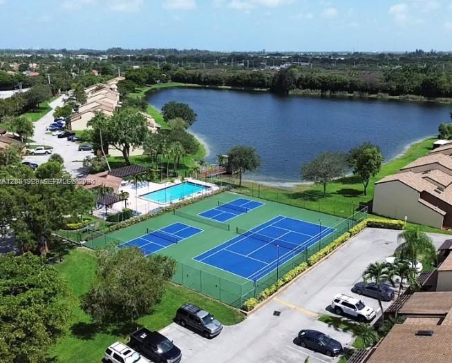 An aerial view shows tennis courts, a swimming pool, a lake, and residential buildings — 4182 S Pine Island Rd, Davie FL 33328, DAVIE, FL