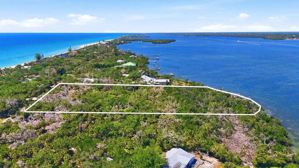 An aerial view shows a rectangular plot of land outlined in white near the water — 0 MANASOTA KEY ROAD, ENGLEWOOD, FL