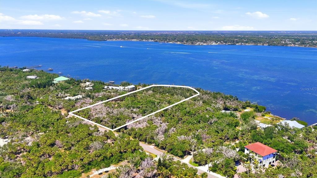 An aerial view shows a rectangular plot of land outlined in white near a large body of water — 0 MANASOTA KEY ROAD, ENGLEWOOD, FL