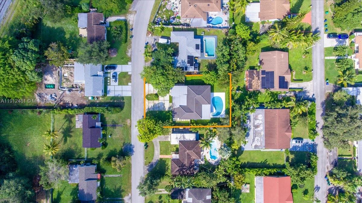 An aerial view shows a residential house with a swimming pool and a driveway — 10845 Peachtree Dr, Miami FL 33161, MIAMI, FL