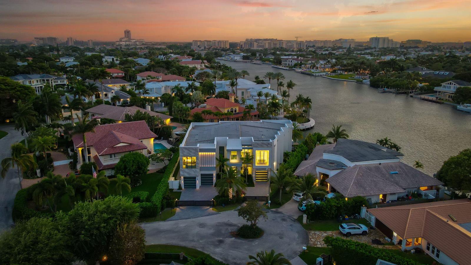 An aerial view of a modern two-story house with a flat roof near a canal — 749 Bamboo Drive, Boca Raton FL 33432, BOCA RATON, FL