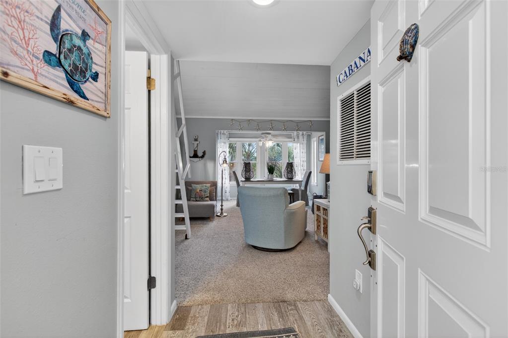 A view from an entryway looking into a living room with a loft ladder — 6300 A1A S UNIT B24U, ST AUGUSTINE, FL