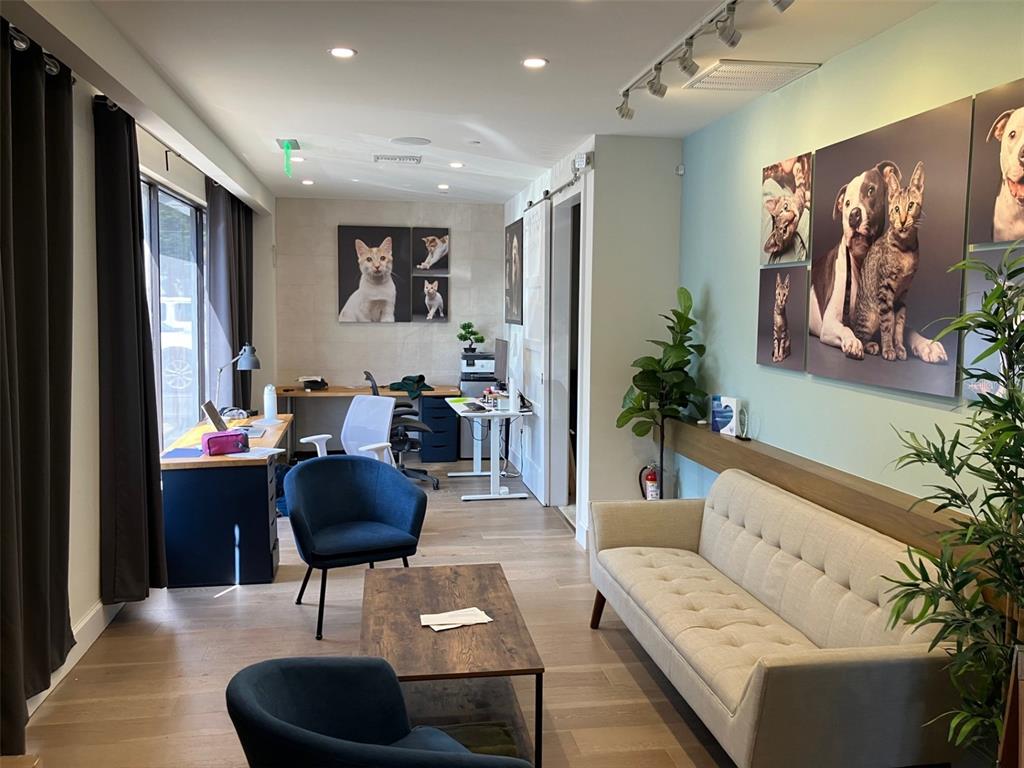 A modern office space features a seating area, two desks, and pet-themed wall art — 3105 W BAY TO BAY BOULEVARD, TAMPA, FL