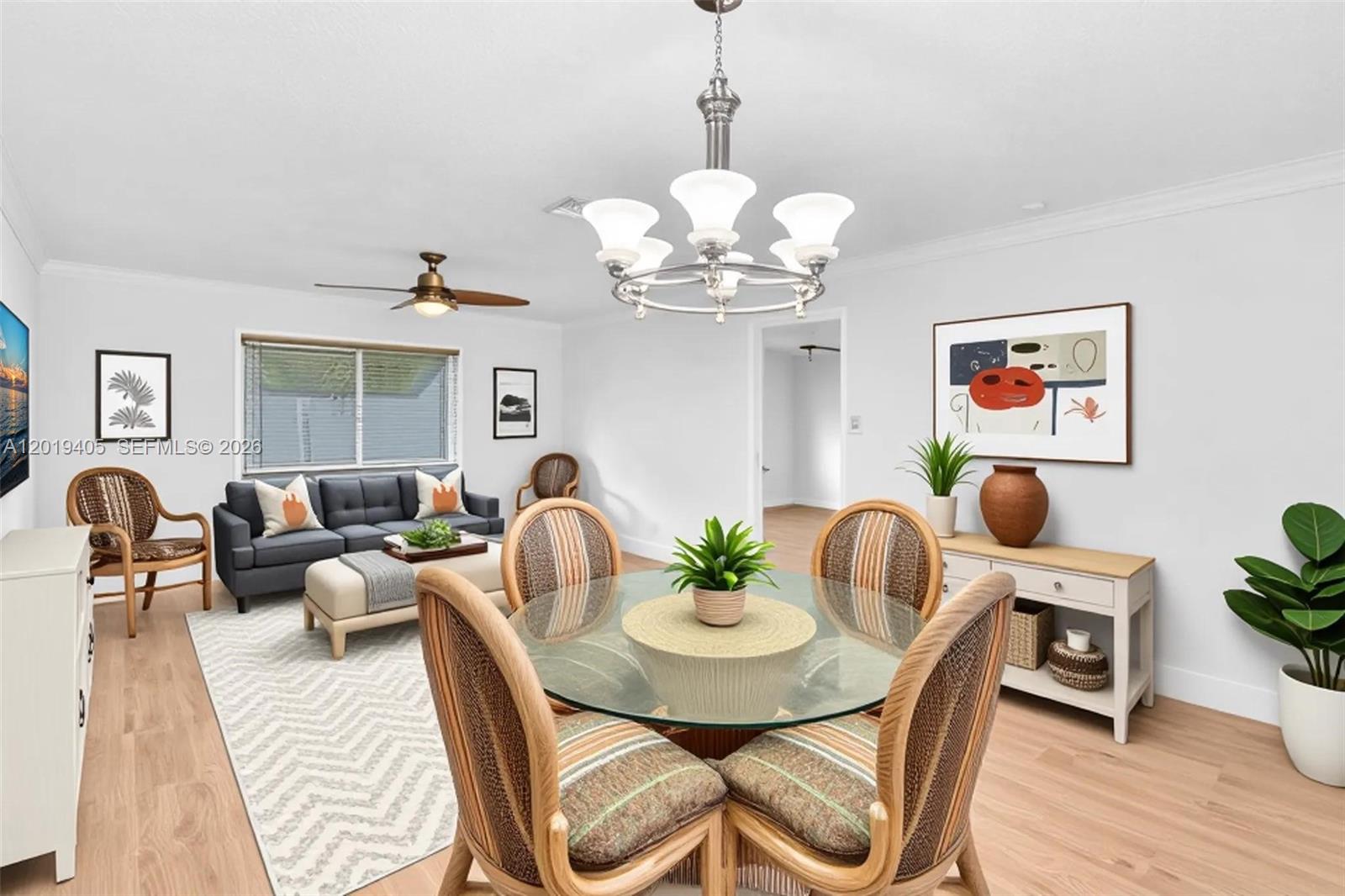 A dining area with a glass table and wicker chairs sits adjacent to a living room — 14898 Wildflower Ln, Delray Beach FL 33446, DELRAY BEACH, FL