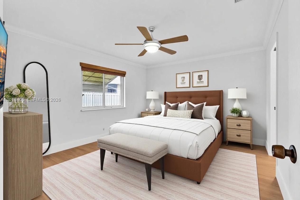 This bedroom features a brown upholstered bed, light wood nightstands, and a ceiling fan — 14898 Wildflower Ln, Delray Beach FL 33446, DELRAY BEACH, FL