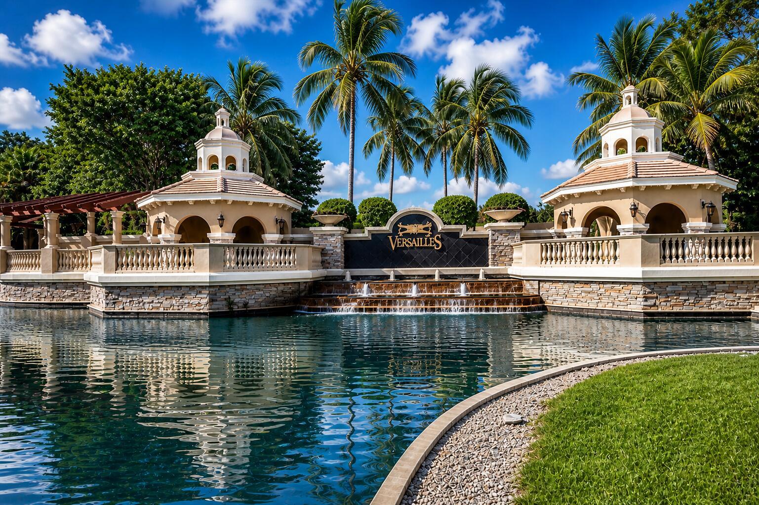 A stone fountain and two gazebos stand beside a pond at the Versailles community entrance — 10295 Trianon Place, Wellington FL 33449, WELLINGTON, FL