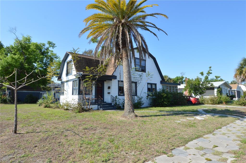 A white house with a gambrel roof and a large palm tree in the yard — 2800 DARTMOUTH AVENUE N, ST PETERSBURG, FL