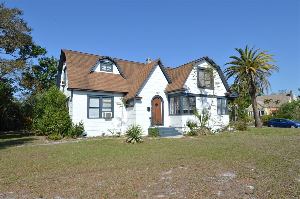 A white two-story house with a brown shingled roof and a palm tree in front — 2800 DARTMOUTH AVENUE N, ST PETERSBURG, FL