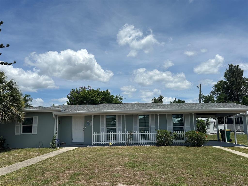 A single-story house with a gray exterior, white shutters, and a covered front porch — 155 DOW ROAD, PORT CHARLOTTE, FL
