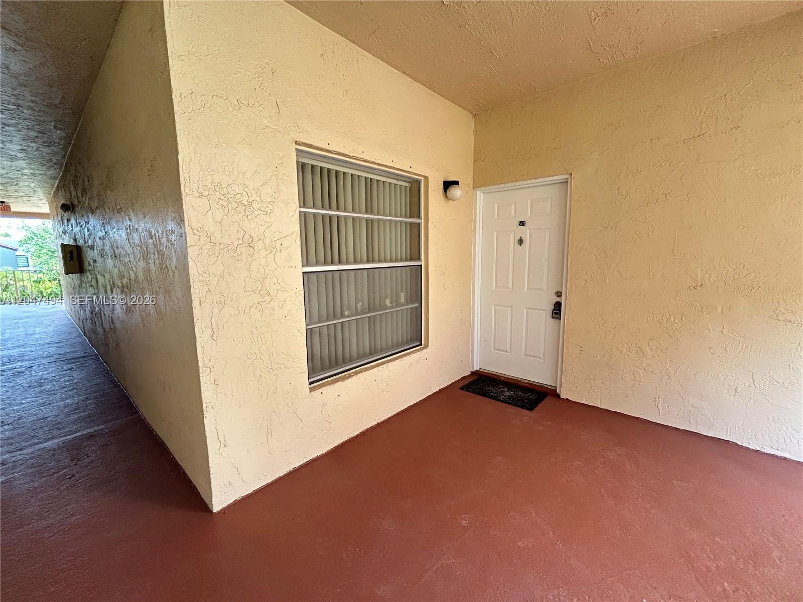 A white door and a window with vertical blinds are set in a textured wall — 15340 SW 106th Ter # 817, Miami FL 33196, MIAMI, FL