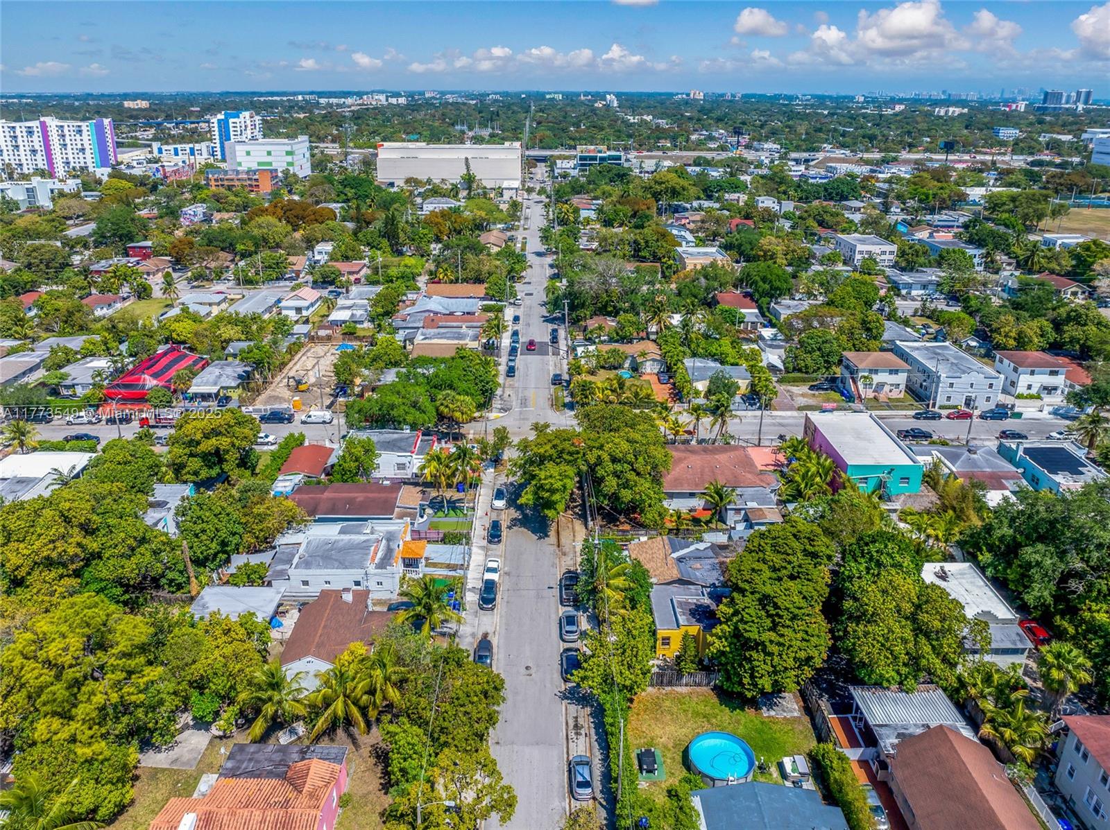An aerial view shows a residential neighborhood with houses, trees, and streets under a blue sky — 3123 NW 3rd Ave, Miami FL 33127, MIAMI, FL
