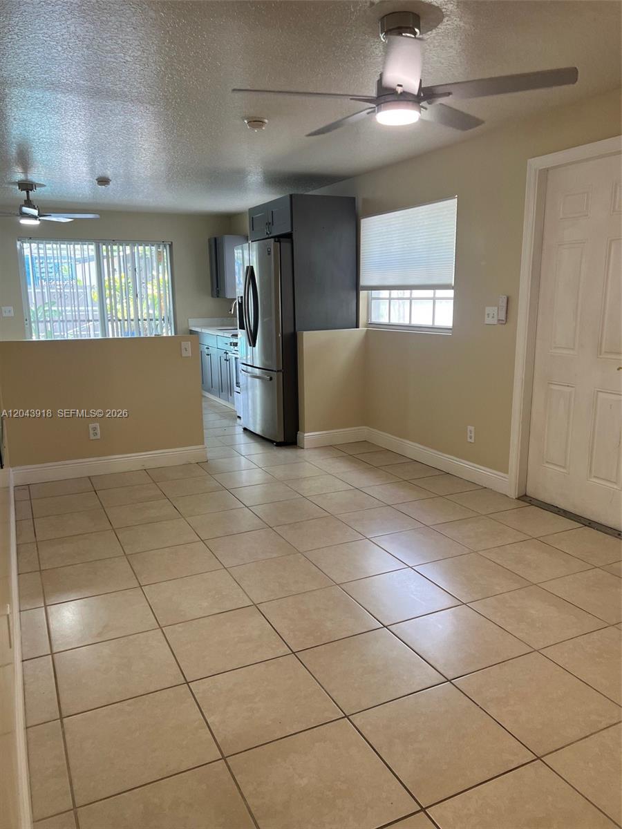A kitchen and dining area feature tile flooring, a ceiling fan, and stainless steel appliances — 0 East Dr. # 0, North Miami Beach FL 33162, NORTH MIAMI BEACH, FL