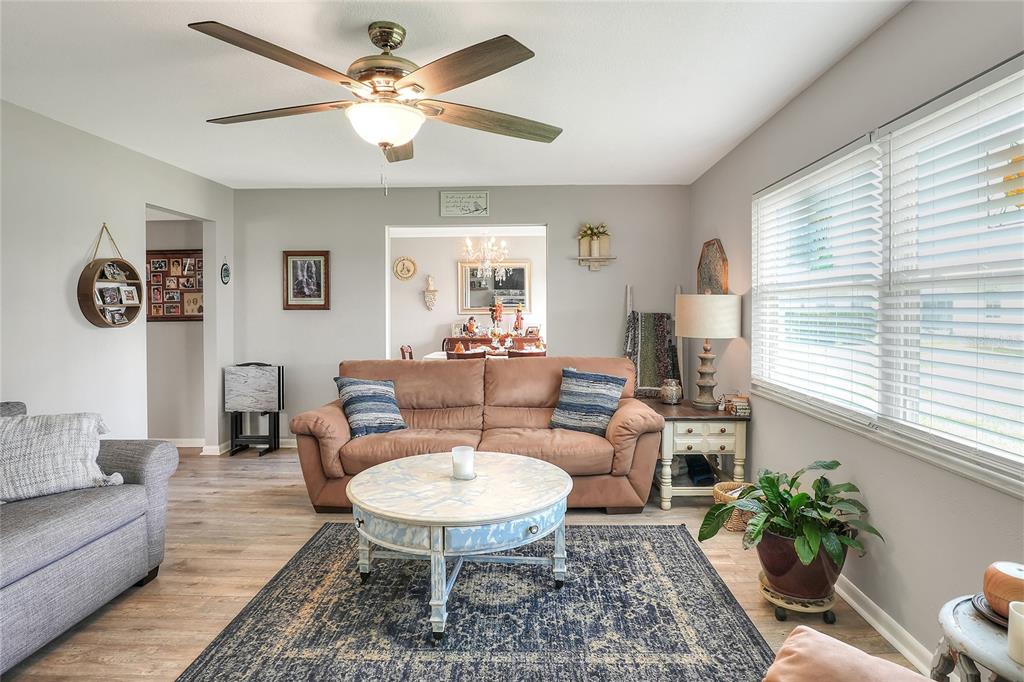 A living room features a brown sofa, a round coffee table, and a ceiling fan — 3515 AMITY AVENUE UNIT 3515, LAKELAND, FL