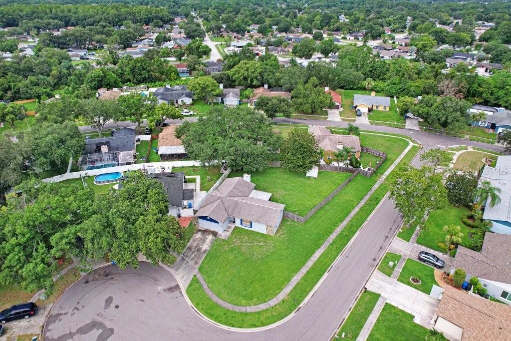 An aerial view shows a single-story house with a large yard and a cul-de-sac street — 4908 CROCKETT COURT, TAMPA, FL