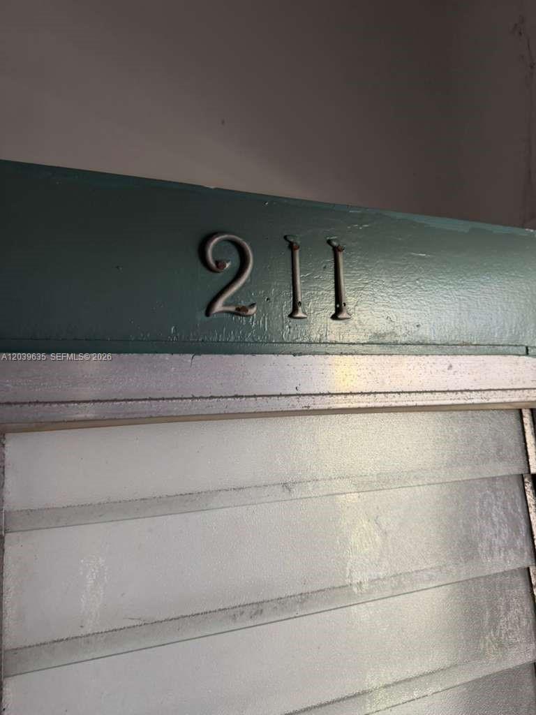 A close-up view of a door with the number 211 mounted above it — MIAMI BEACH, FL