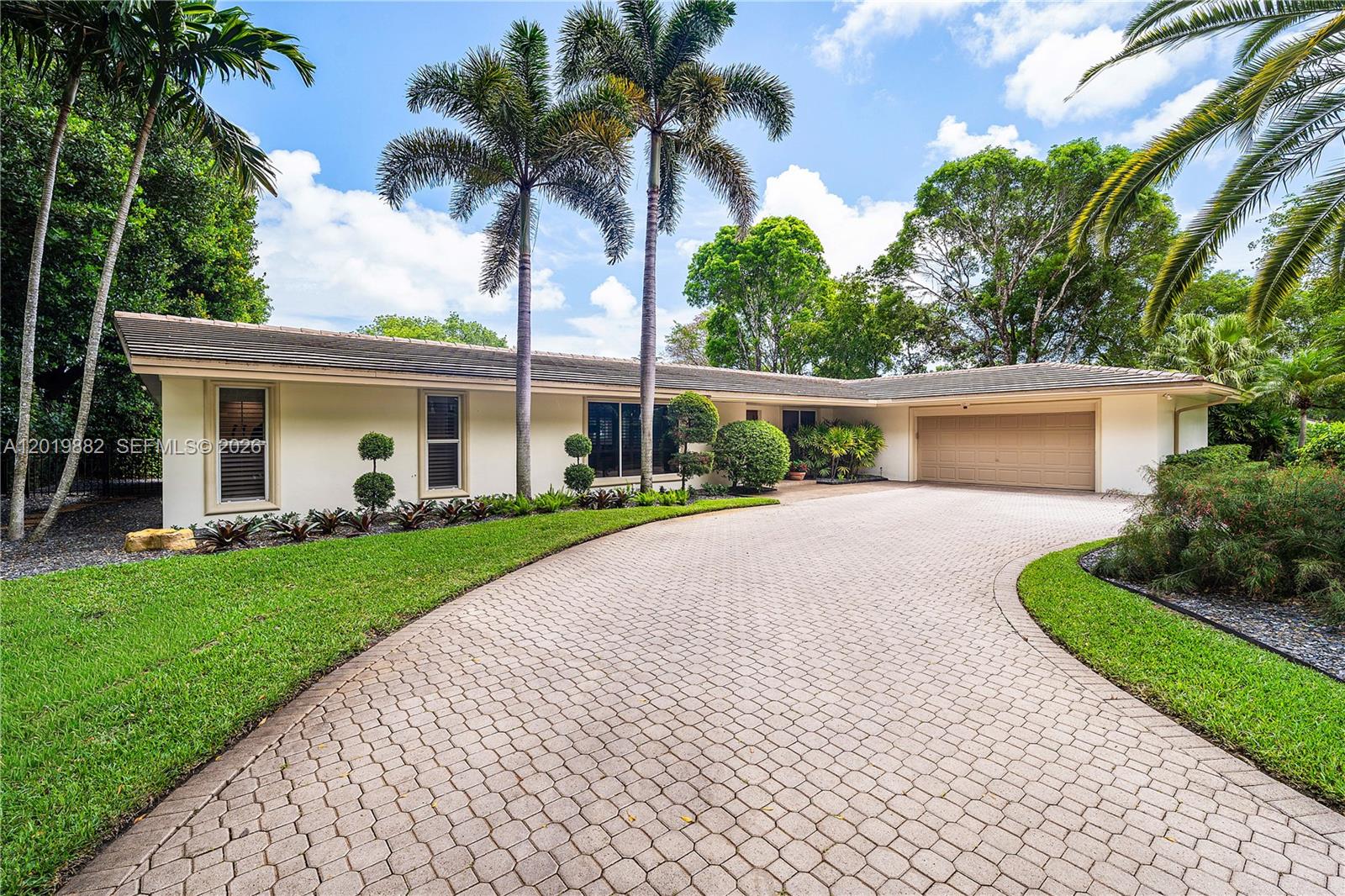 A single-story house with a paved driveway, palm trees, and a two-car garage — 4301 Sanders St, Hollywood FL 33021, HOLLYWOOD, FL