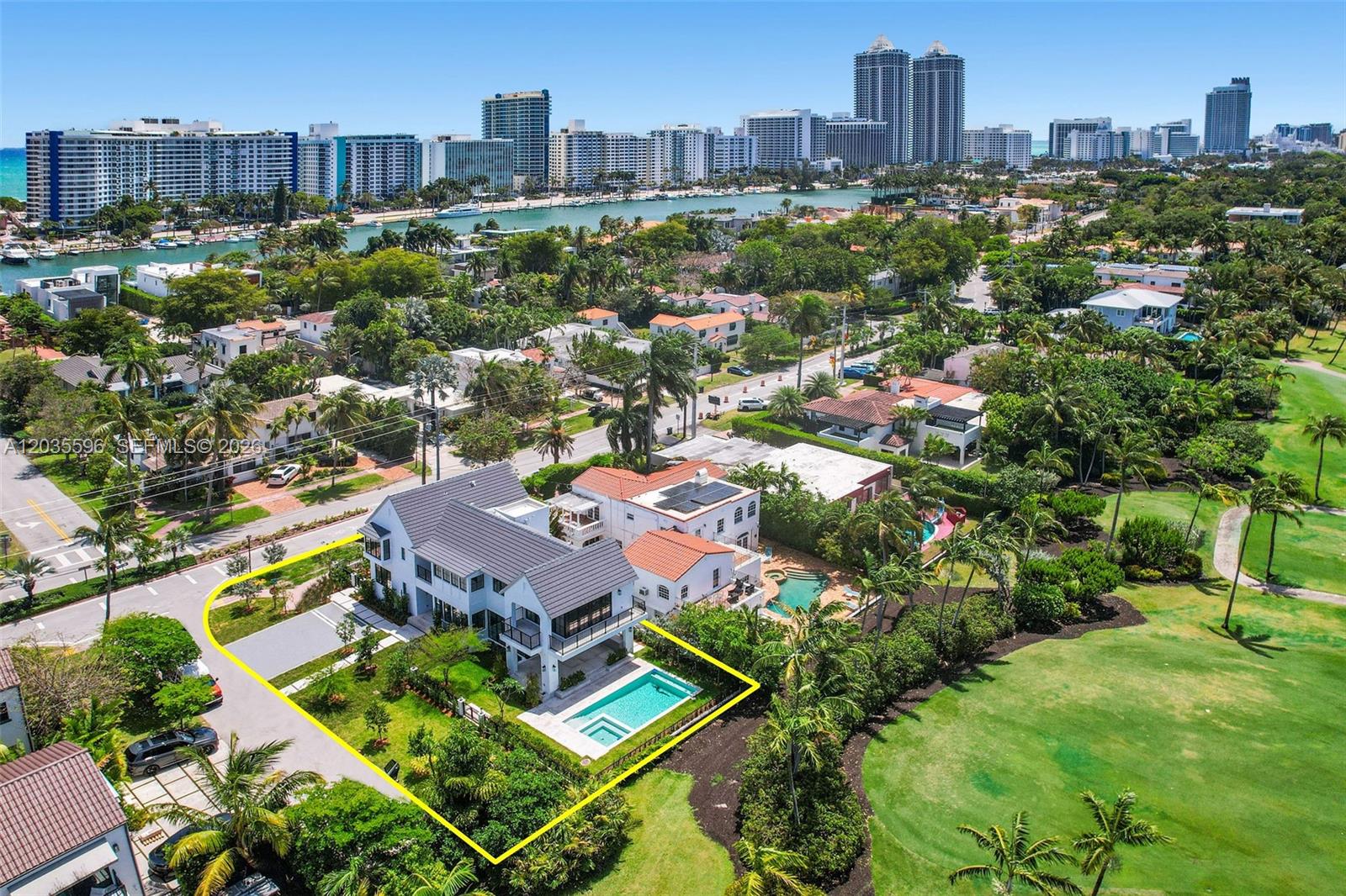 An aerial view shows a two-story house with a pool, lawn, and adjacent golf course — 5262 La Gorce Dr, Miami Beach FL 33140, MIAMI BEACH, FL