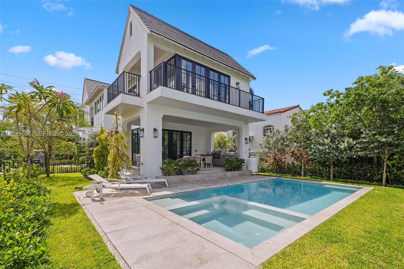 A two-story white house features a covered patio, a swimming pool, and a balcony — 5262 La Gorce Dr, Miami Beach FL 33140, MIAMI BEACH, FL