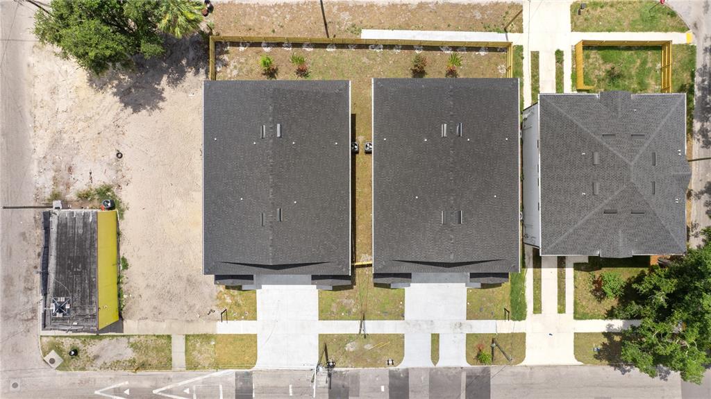 An aerial view shows three residential buildings with dark roofs, concrete walkways, and surrounding landscaping — 2808 N 29TH STREET UNIT 2, TAMPA, FL
