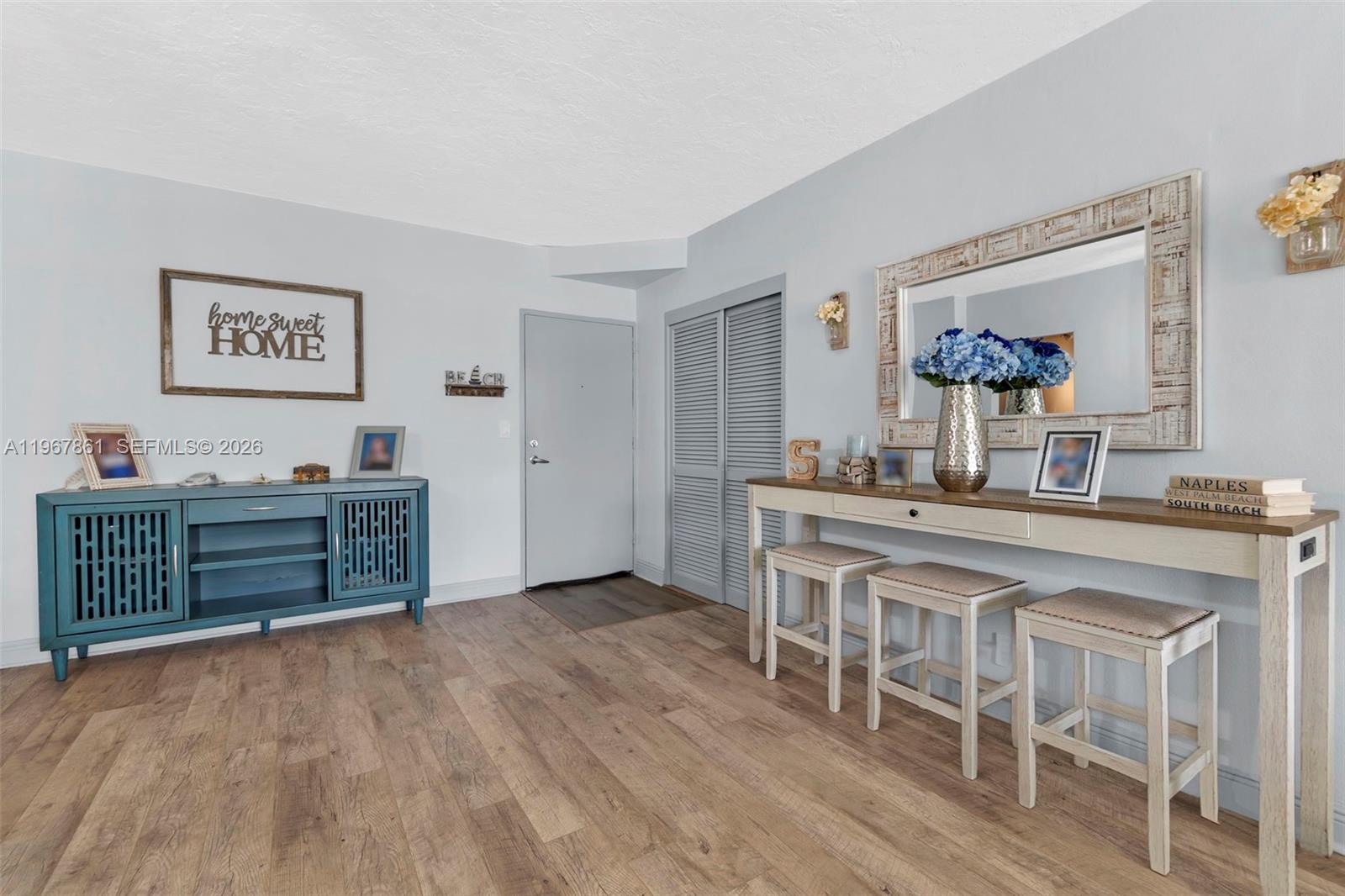 A room features light wood flooring, a blue cabinet, and a console table with stools — 3000 S Ocean Dr # 1122, Hollywood FL 33019, HOLLYWOOD, FL