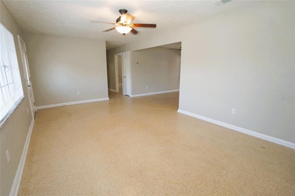 An empty room with light-colored walls, a ceiling fan, and speckled flooring — 206 S WESTSHORE BOULEVARD, TAMPA, FL