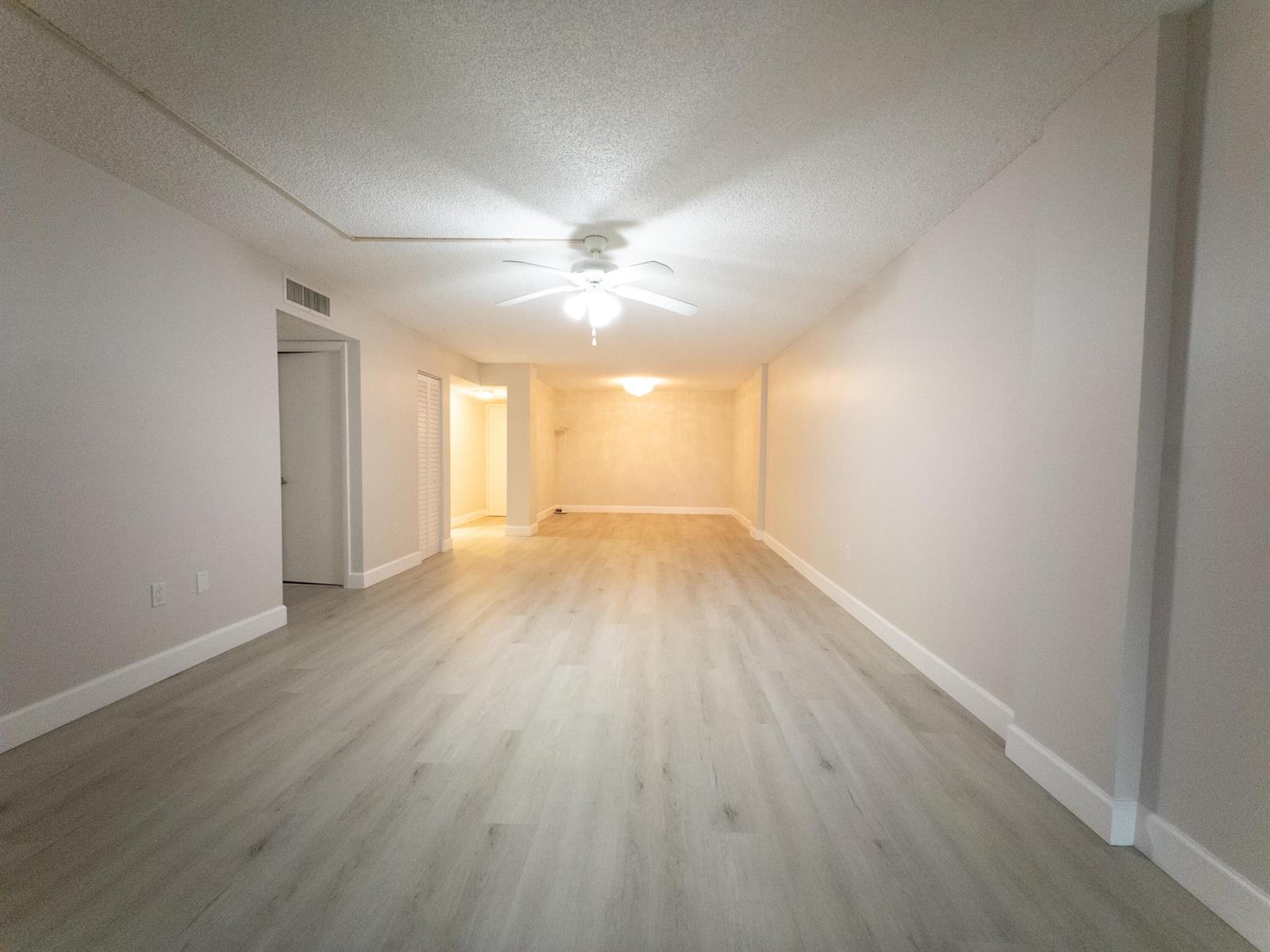 This bedroom features a neutral color palette, a ceiling fan, and light wood furniture — 2800 N 46th # A502, Hollywood FL 33021, HOLLYWOOD, FL