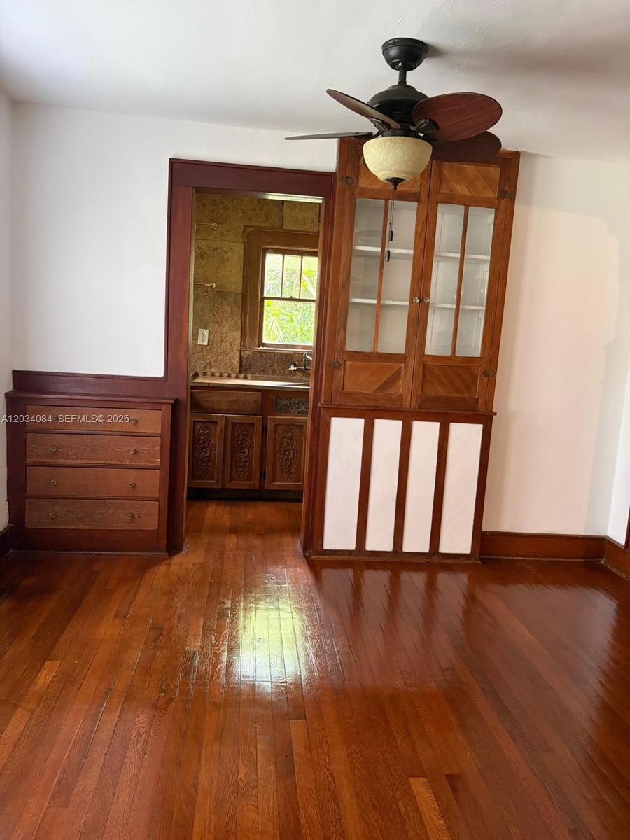 A stone house with red-trimmed windows sits in a yard surrounded by mature trees — 8238 NE 9th Ave, Miami FL 33138, MIAMI, FL