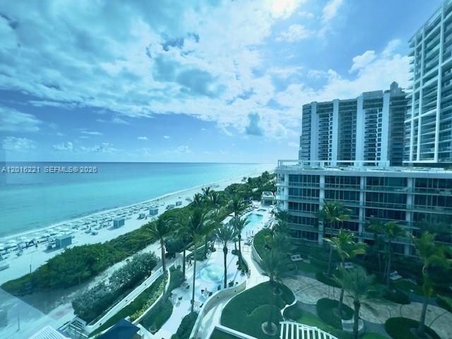 An elevated view shows a beach, swimming pools, and high-rise buildings along the coast — 6801 Collins Ave, Miami Beach FL 33141, MIAMI BEACH, FL