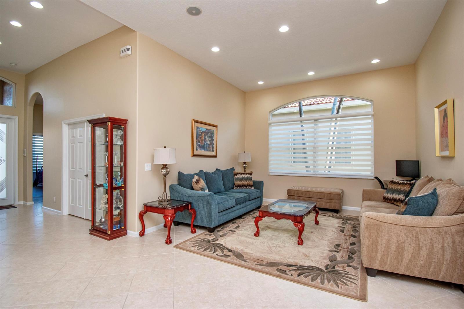 A living room features a blue sofa, a beige sofa, and a glass-topped coffee table — 7080 Demedici Circle # 7080, Delray Beach FL 33446, DELRAY BEACH, FL