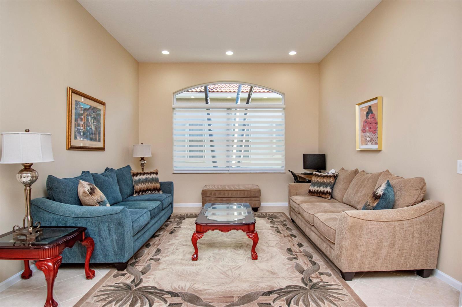 A living room features two sofas, a central coffee table, and an arched window — 7080 Demedici Circle # 7080, Delray Beach FL 33446, DELRAY BEACH, FL