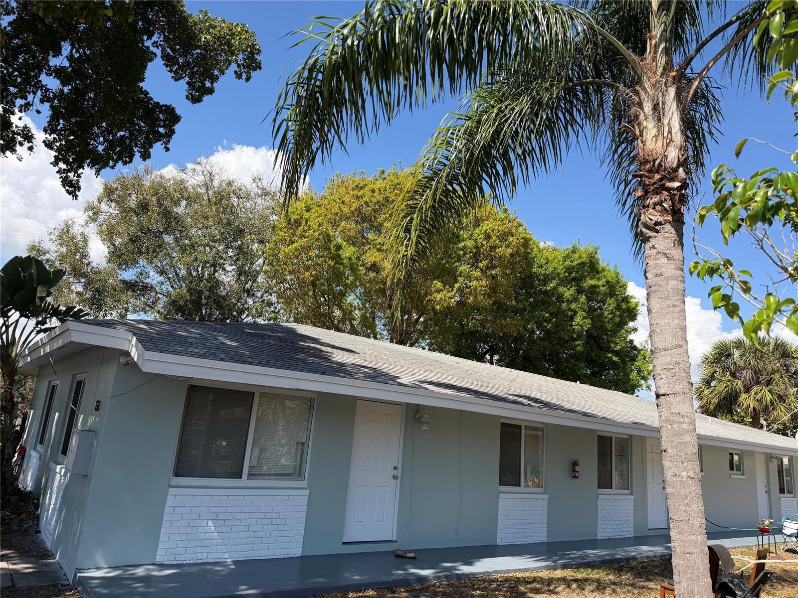 A light blue, single-story building with white brick accents and a palm tree in front — 131 SW 14th Court, Pompano Beach FL 33060, POMPANO BEACH, FL