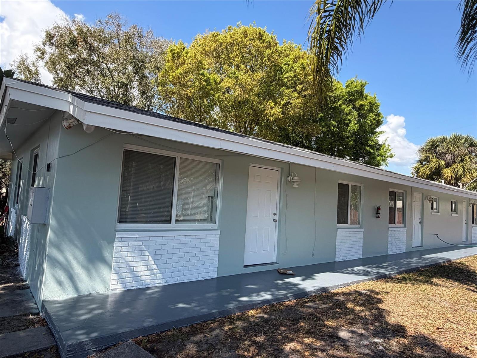 A single-story building with light green siding, white brick accents, and a gray concrete walkway — 131 SW 14th Court, Pompano Beach FL 33060, POMPANO BEACH, FL