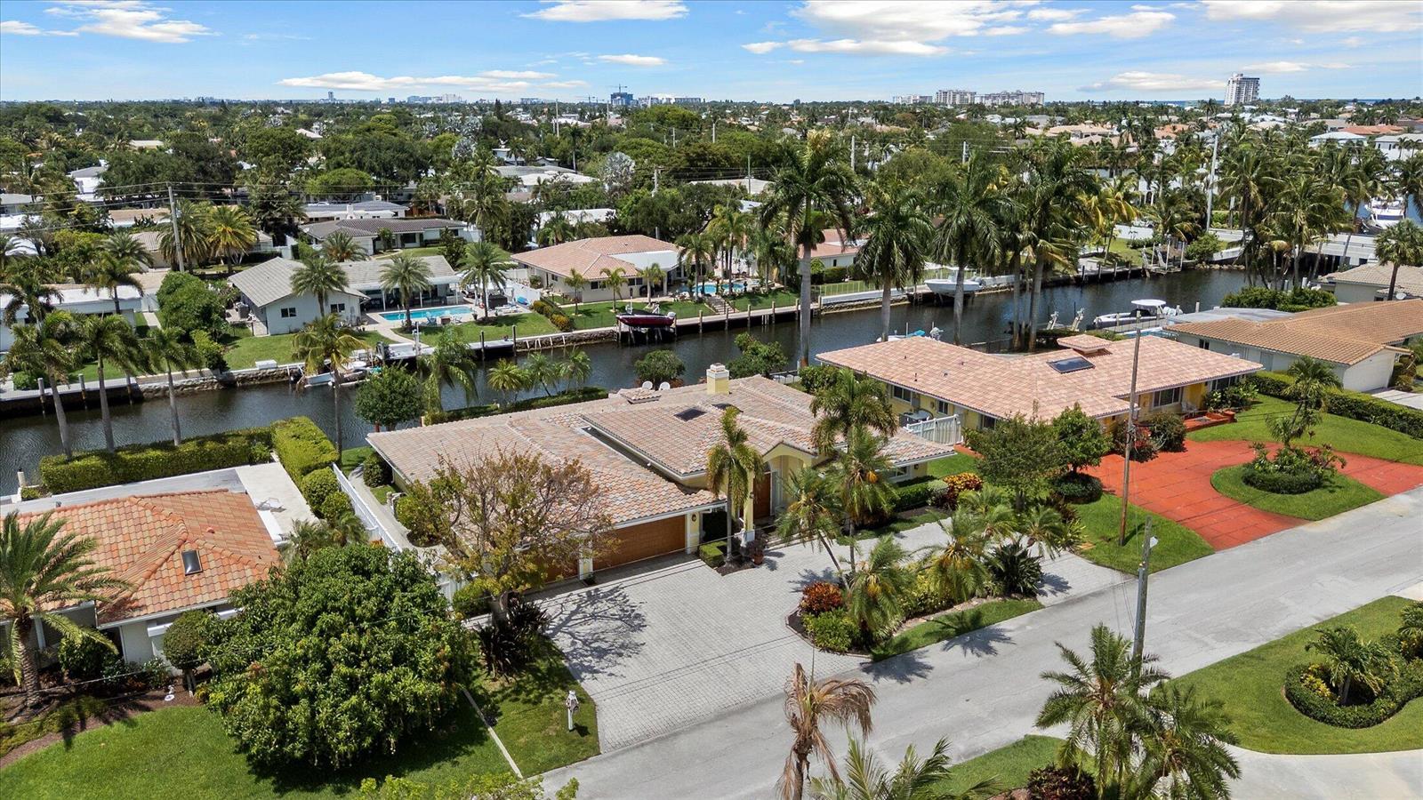 An aerial view shows waterfront houses with tile roofs, swimming pools, and boat docks — 2141 NE 29th Street, Lighthouse Point FL 33064, LIGHTHOUSE POINT, FL