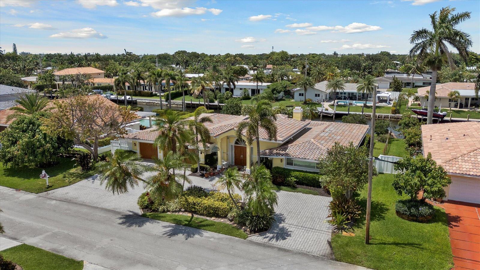An aerial view of a yellow single-story house with a tiled roof and paved driveway — 2141 NE 29th Street, Lighthouse Point FL 33064, LIGHTHOUSE POINT, FL