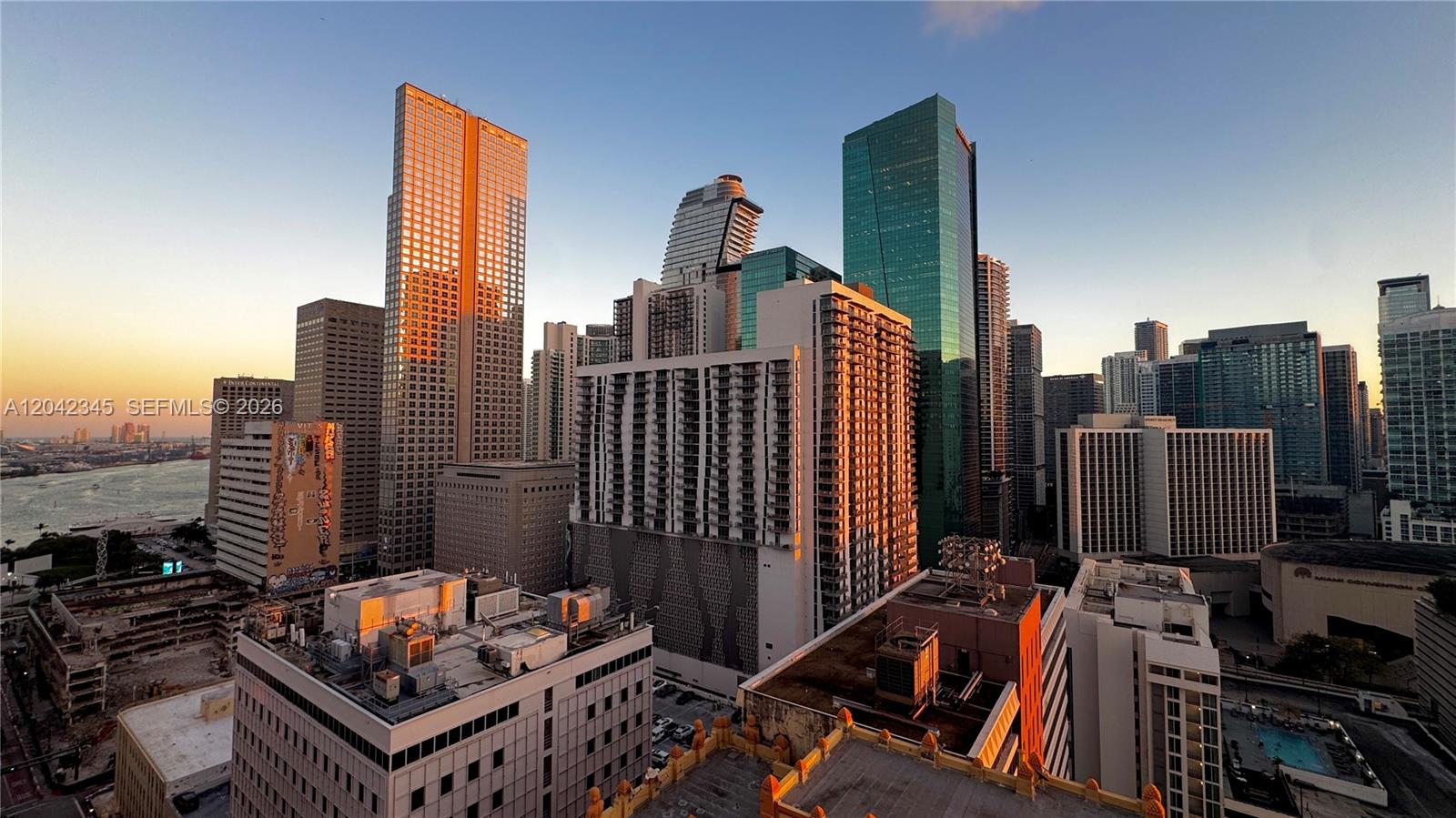 An elevated view of the Miami skyline featuring various high-rise buildings during sunset — 151 SE 1st St # 2205, Miami FL 33131, MIAMI, FL